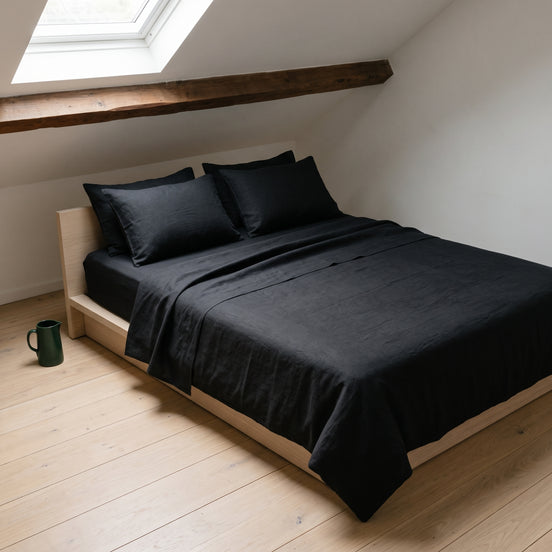 Double bed made up in the full deep black linen set