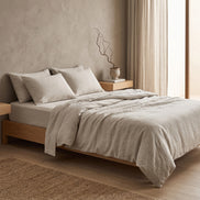 Double bed made up in the full pale oatmeal linen set