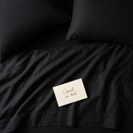 Deep black bed linen set seen from above