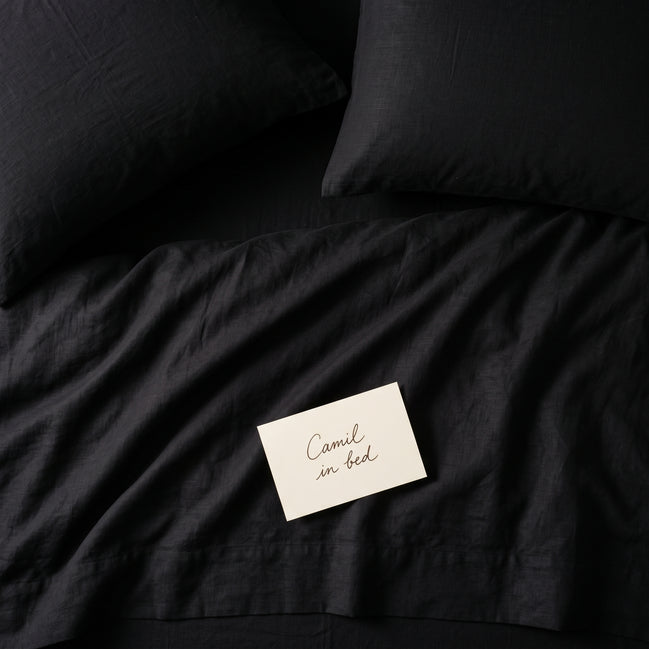 Deep black bed linen set seen from above