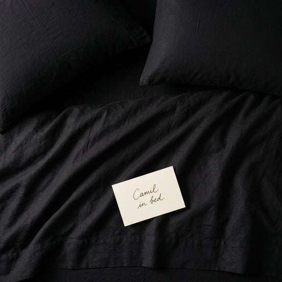 Deep black bed linen set seen from above