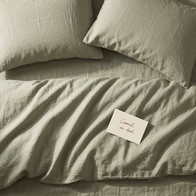 Soft sage green bed linen set seen from above