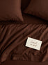 Deep brown bed linen set seen from above