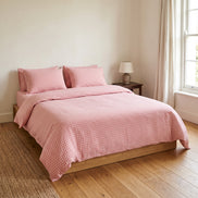 Double bed made up in the full dusty pink checked linen set