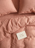 Dusty terracotta striped bed linen set seen from above