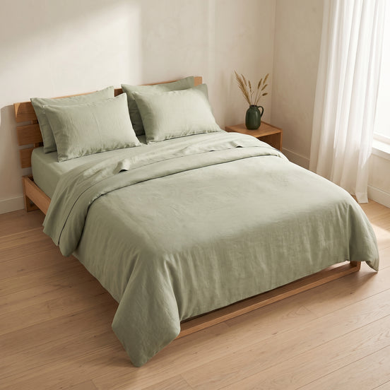 Double bed made up in the full sage green linen set