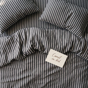 Deep charcoal striped bed linen set seen from above