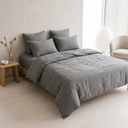 Double bed made up in the full charcoal striped linen set