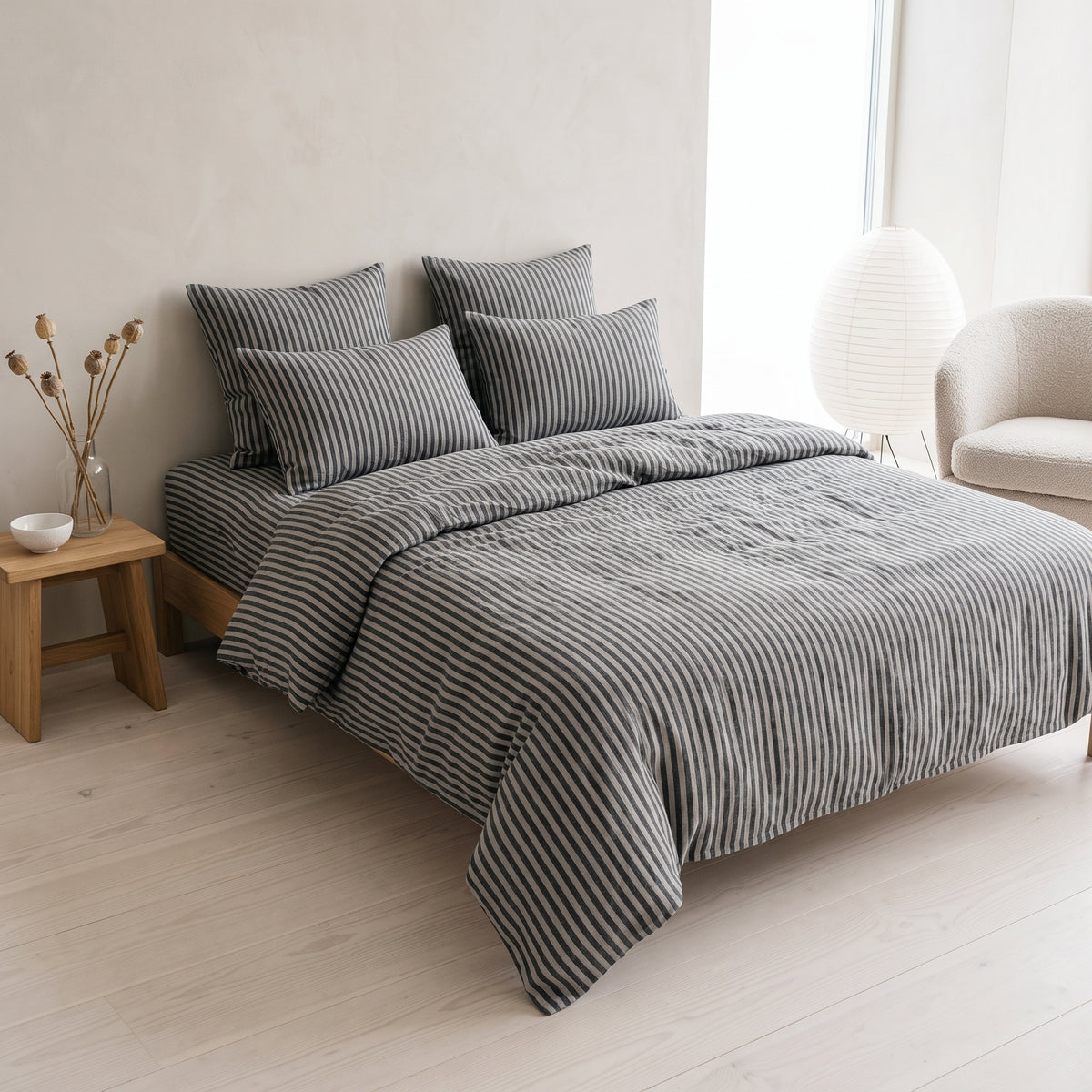 Double bed made up in the full charcoal striped linen set
