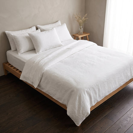 Double bed made up in the full warm white linen set