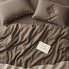 Warm taupe bed linen set seen from above